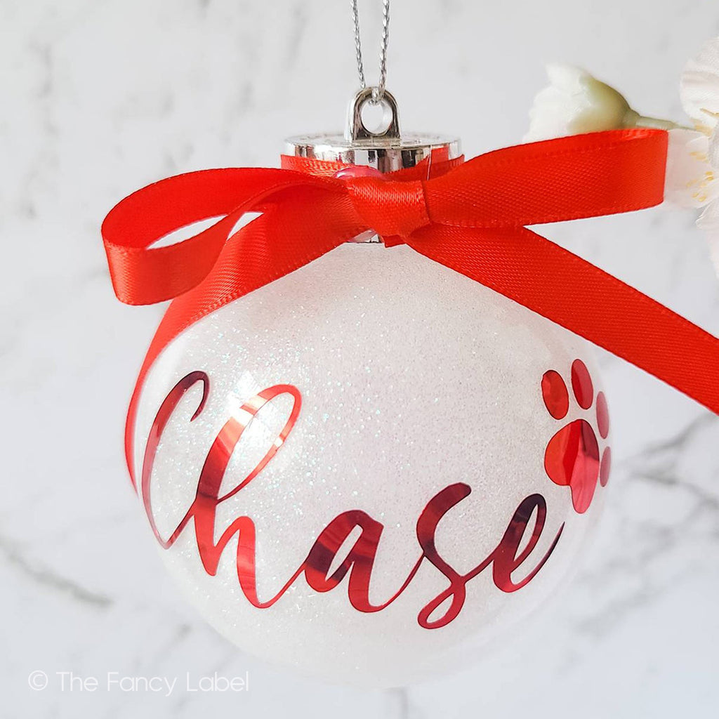 Pet name personalised christmas bauble with glitter and bow and paw print white and red